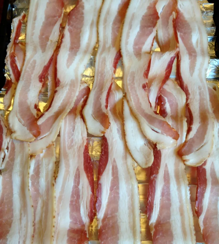 Bacon on a cookie sheet ready to go into the oven.