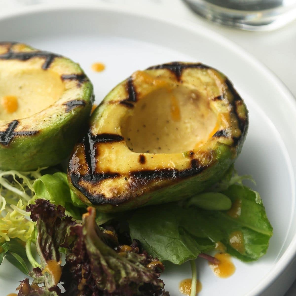 Grilled avocado halves showing grill marks