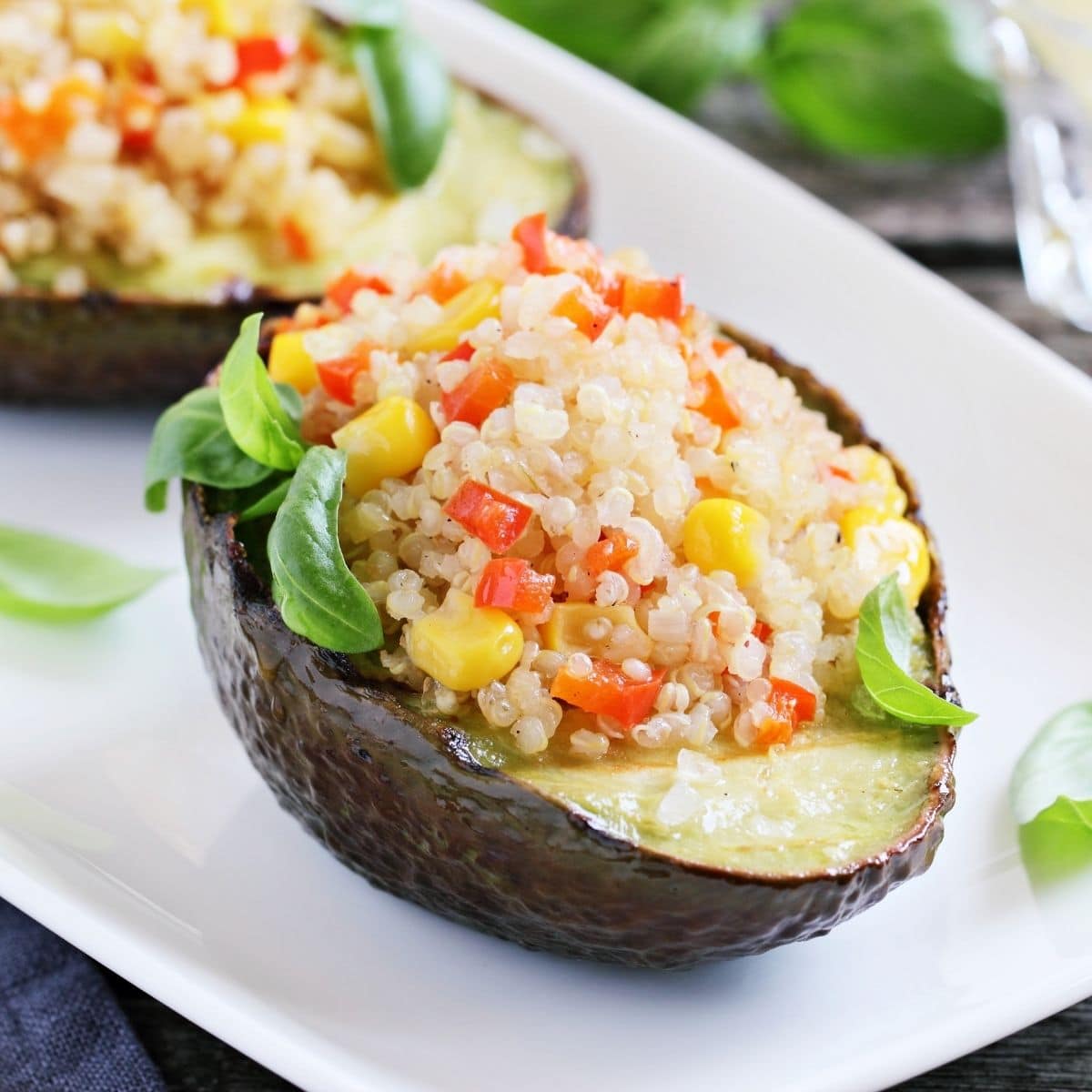 Grilled avocado stuffed with quinoa, corn, and tomatoes