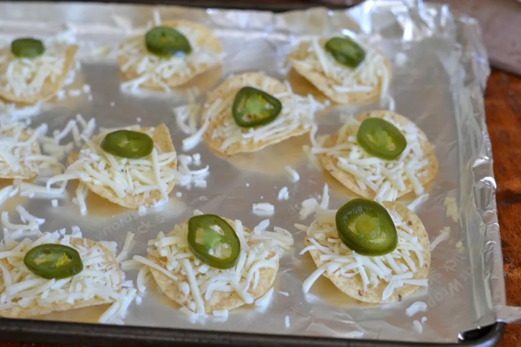 Nachos on a cookie sheet, ready to be baked