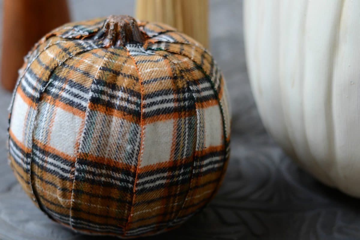 Craft pumpkin covered in plaid fabric.