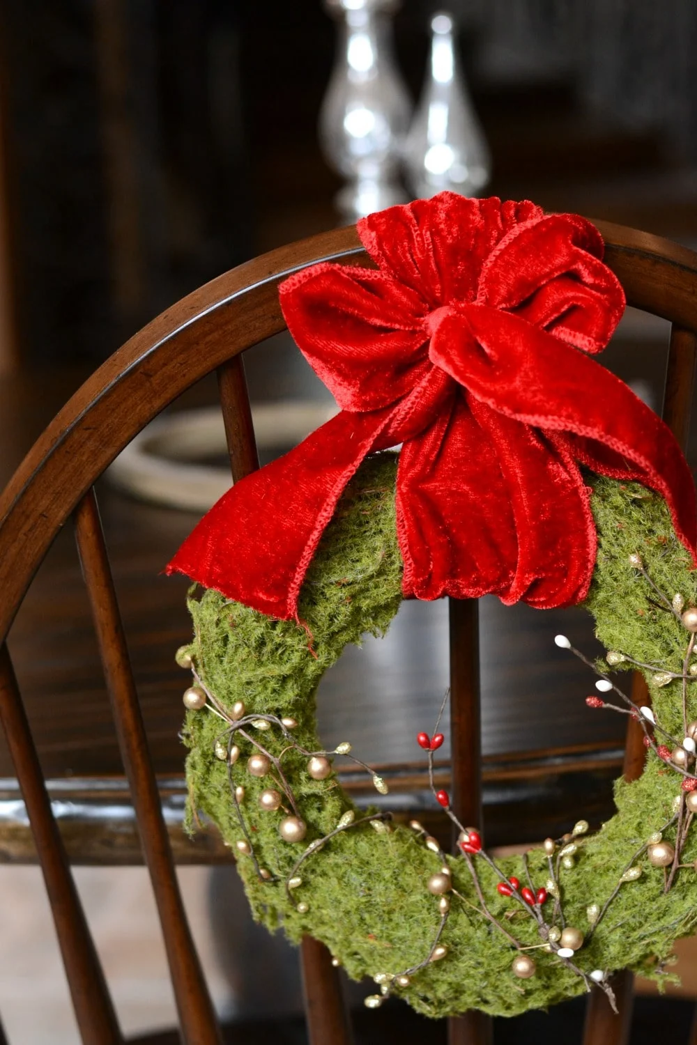 Hang wreath over the back of a dining chair