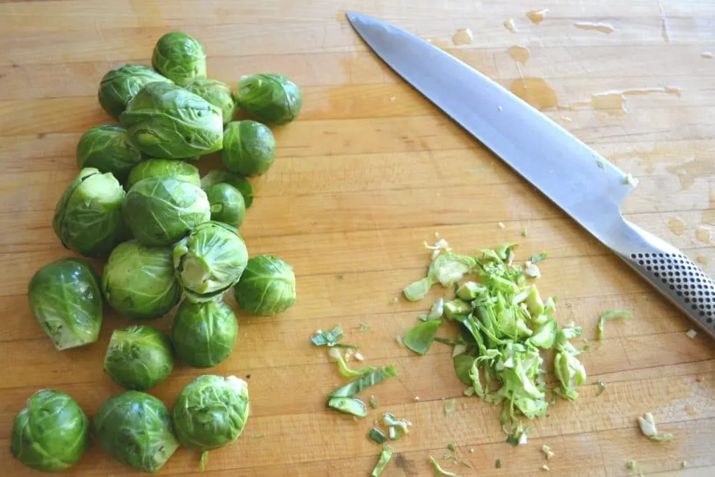 Brussels sprouts on a cutting board.