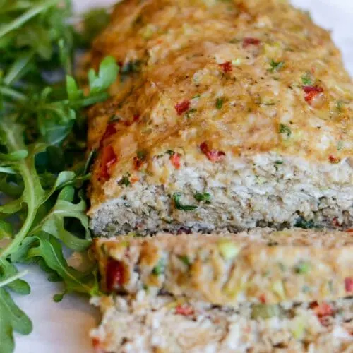 Close up of sliced turkey meatloaf sliced on a plate.
