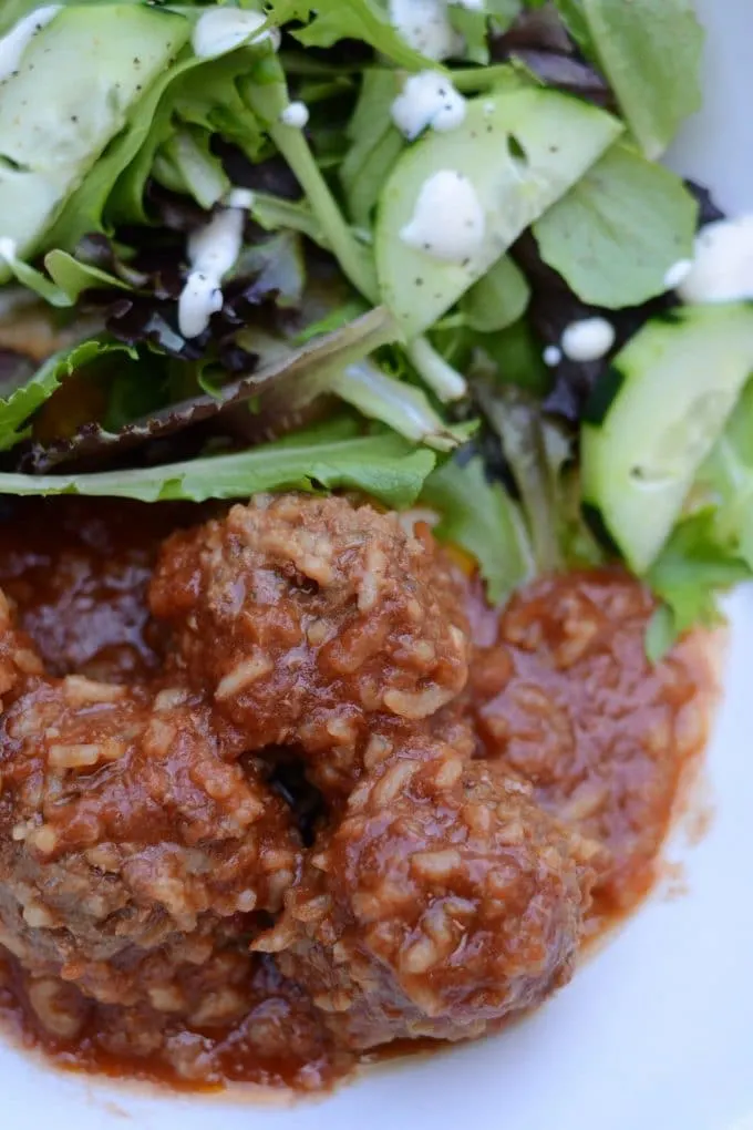 Porcupine meatballs on a plate with salad