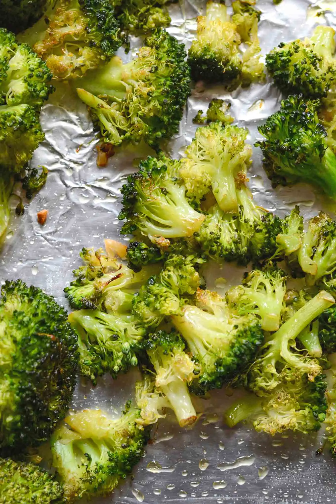 Garlic roasted broccoli on a roasting pan.