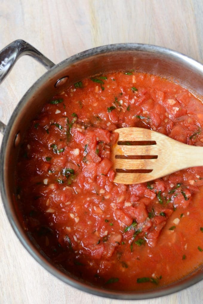 Tomato sauce simmering in a pan.