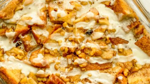 Baked French toast casserole in a baking dish with glaz.