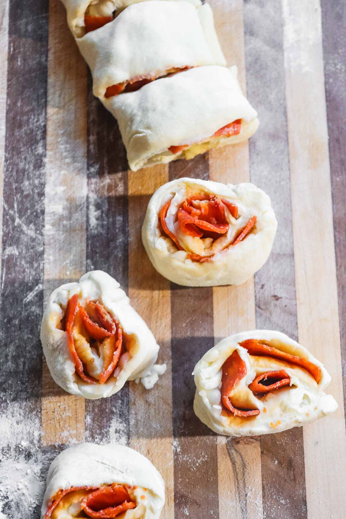 Rolled up dough with pepperoni sliced into pinwheels