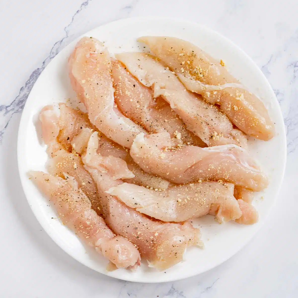 Chicken tenders seasoned with salt, pepper, garlic powder, onion powder