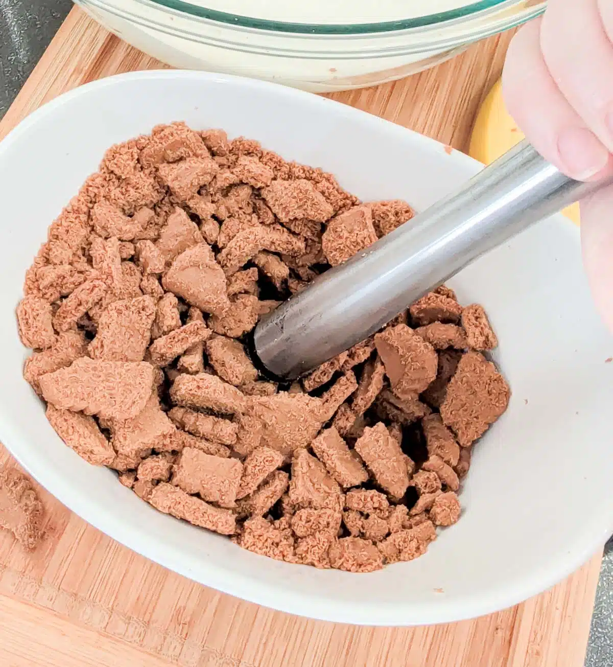 Crushing Biscoff cookies with a muddler