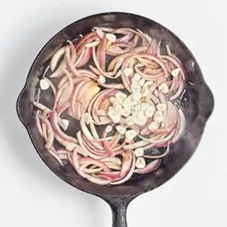 Sauteed red onion and garlic in a skillet