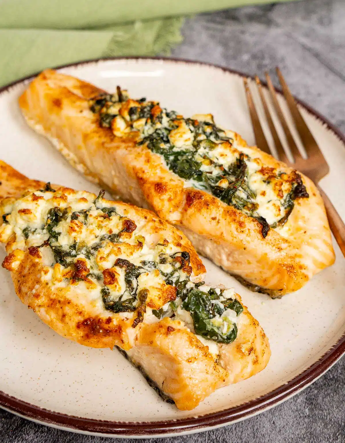 2 salmon fillets stuffed with feta and spinach on a plate