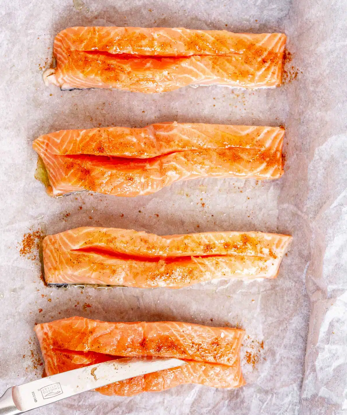 Salmon fillets with slits cut in them