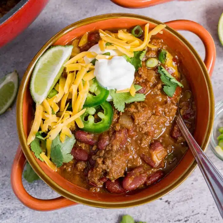 Bowl of ground venison chili with toppings