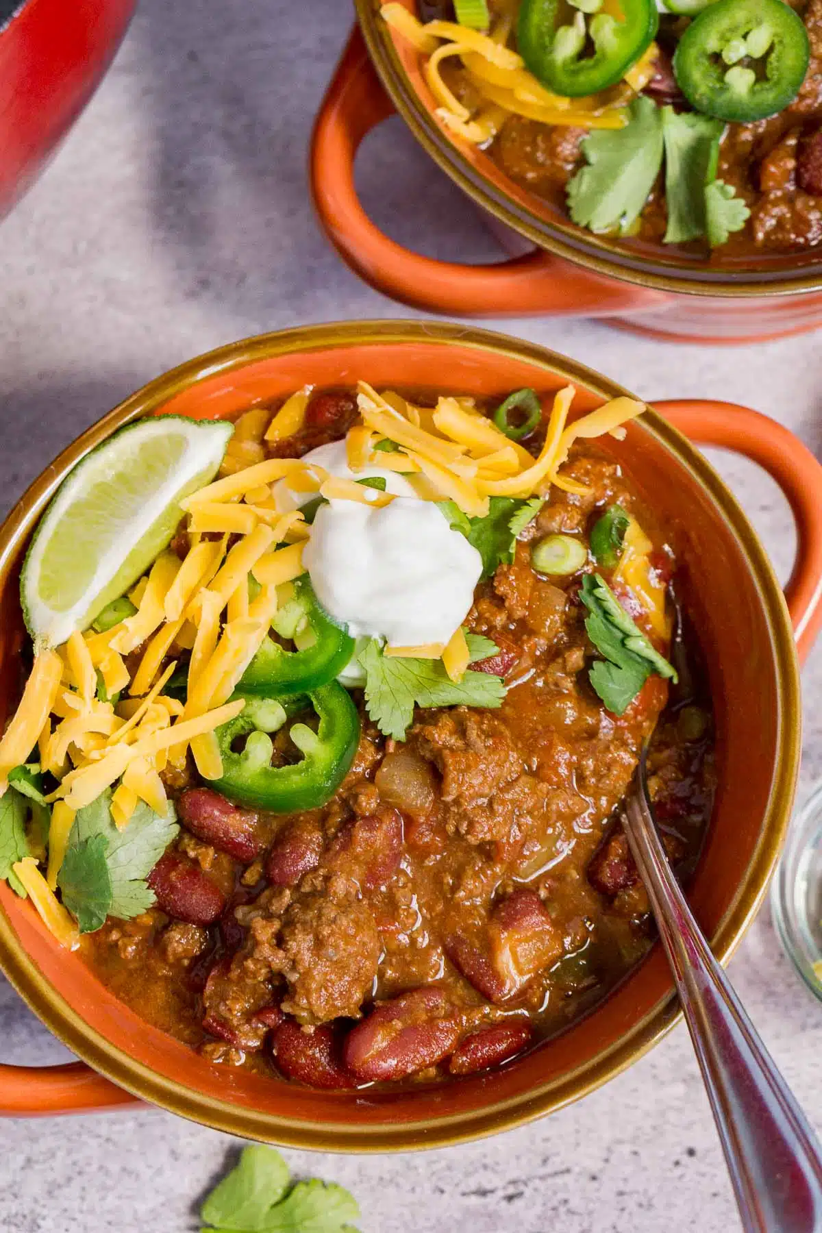 Bowl of ground venison chili with toppings