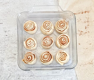 Crescent dough cinnamon rolls in prepared baking pan ready to bake