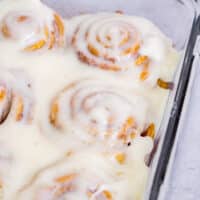 Crescent cinnamon rolls with cream cheese glaze in a baking dish