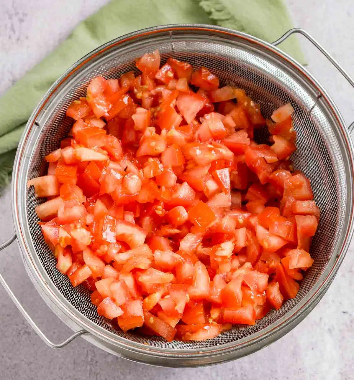 Diced tomatoes draining in a colander