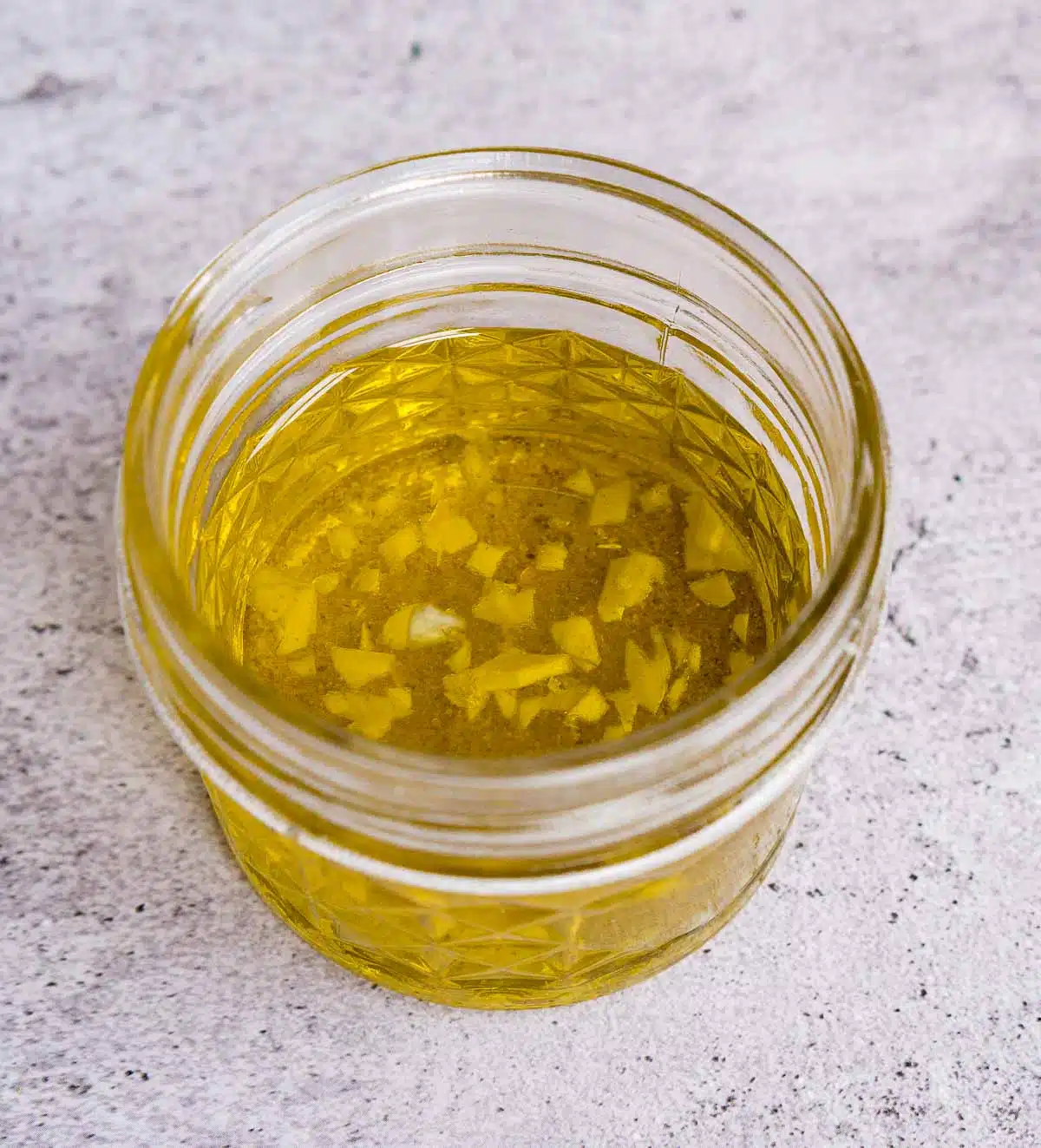 Minced garlic in a jar of olive oil