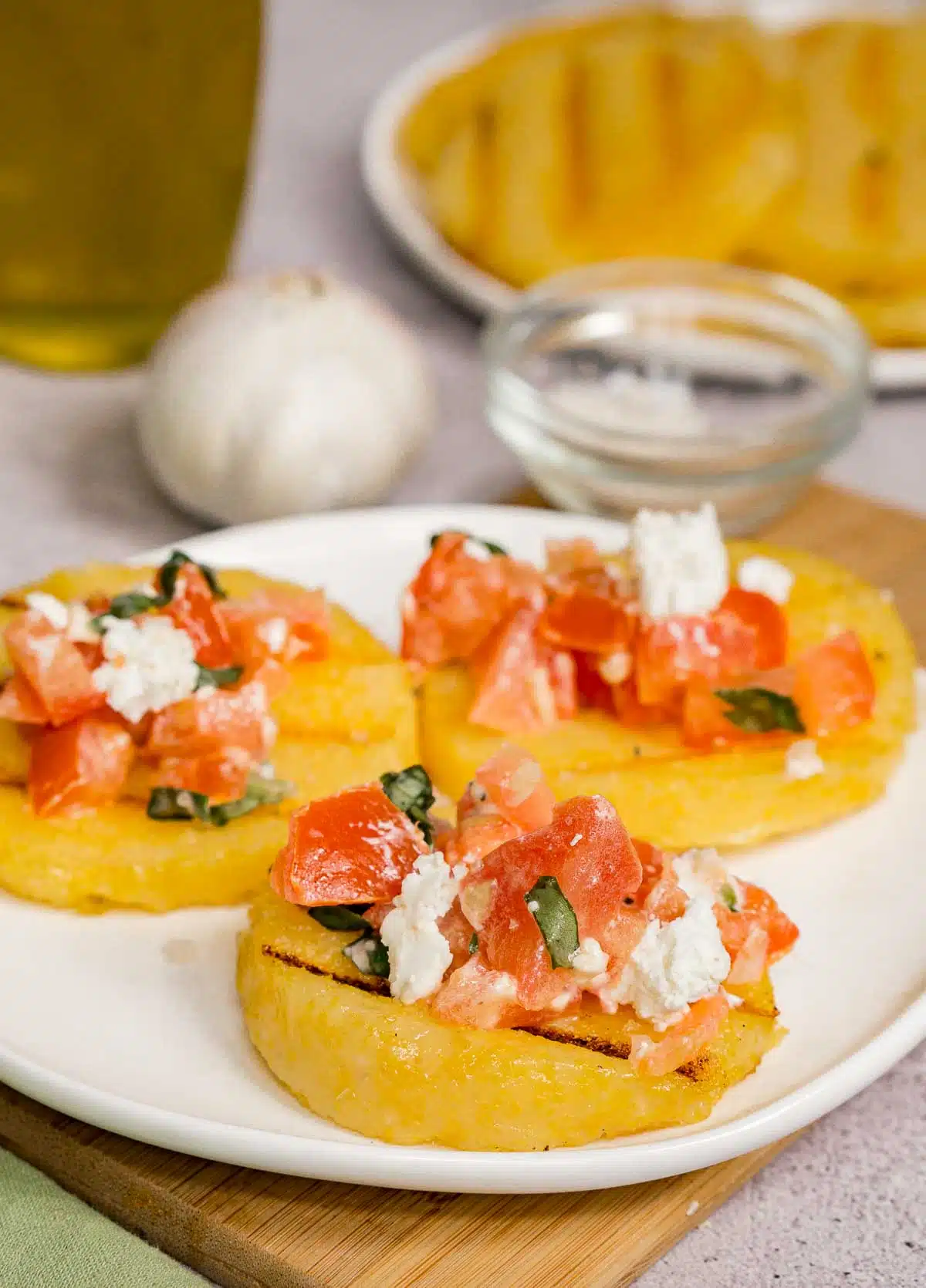 Grilled polenta slices topped with bruschetta