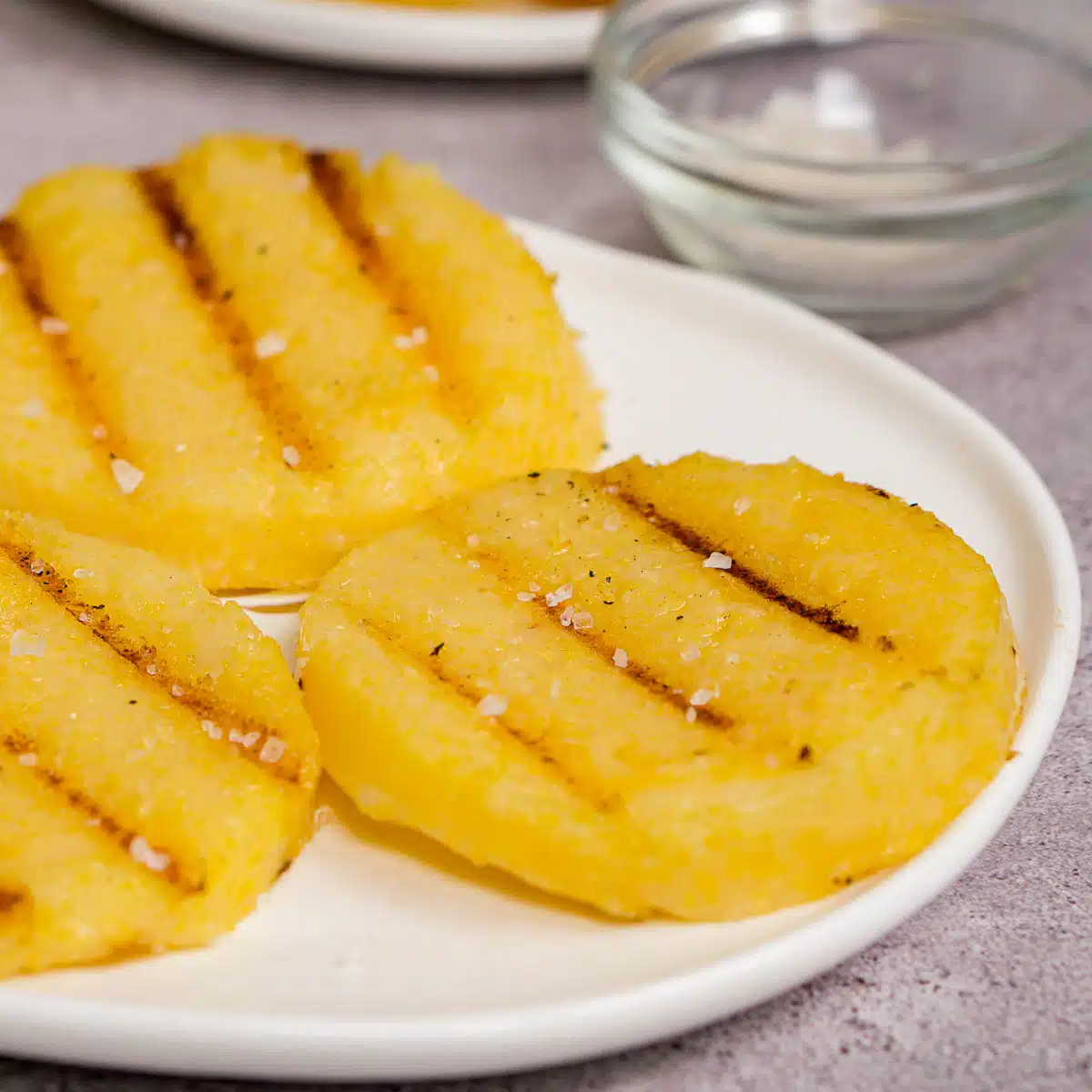 Close up of grilled polenta slices sprinkled with sea salt