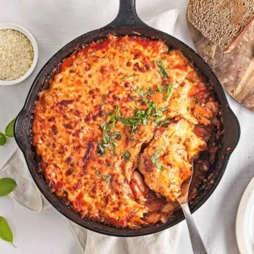 Skillet of baked cheesy pizza beans
