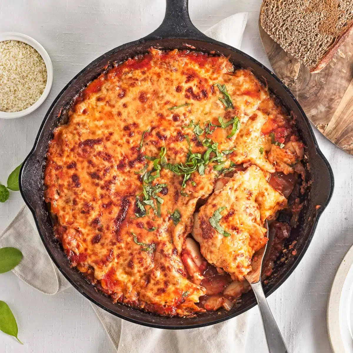 Skillet of baked cheesy pizza beans