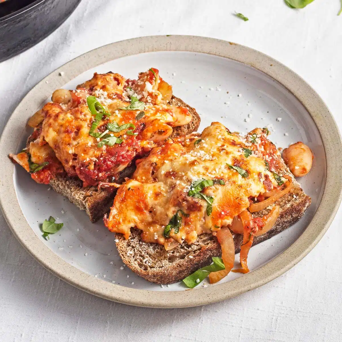 Two slices of bread topped with saucy pizza beans
