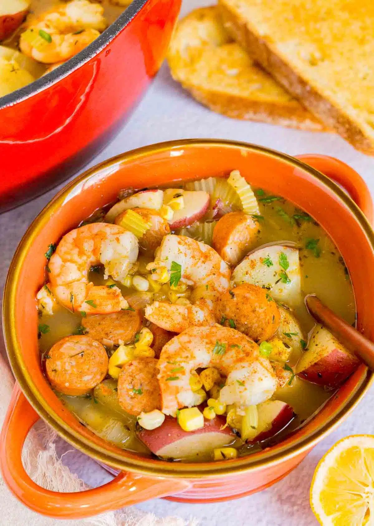 Close up of a bowl of shrimp boil soup