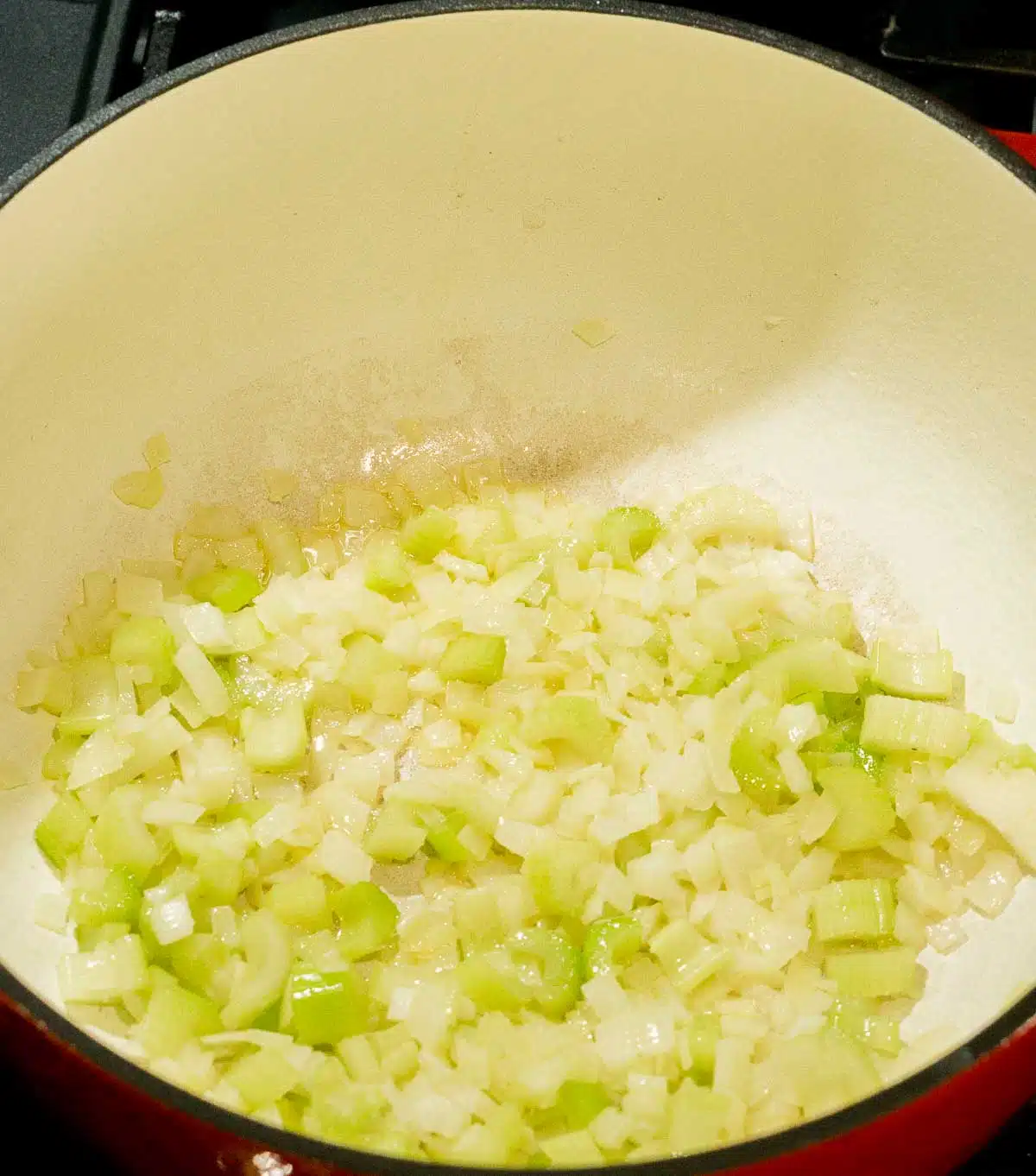 Sauteed diced onion and celery in a soup pot
