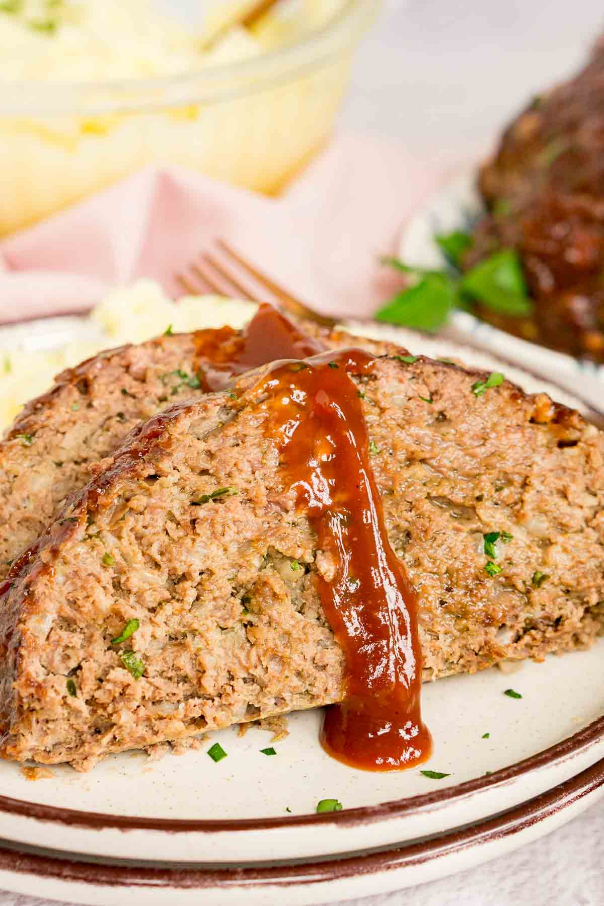 Venison meatloaf topped with glaze on a plate
