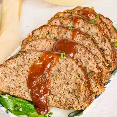 Sliced venison meatloaf with glaze on a serving platter