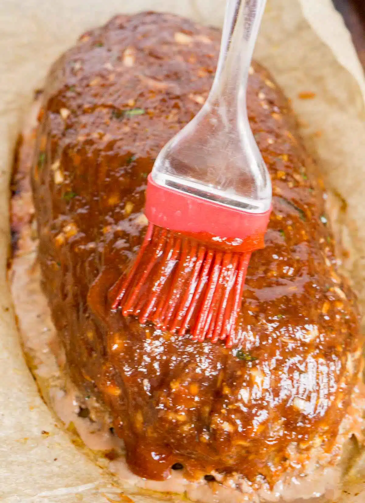 Brushing glaze onto meatloaf