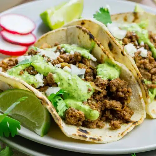 Bison tacos with avocado sauce on a plate