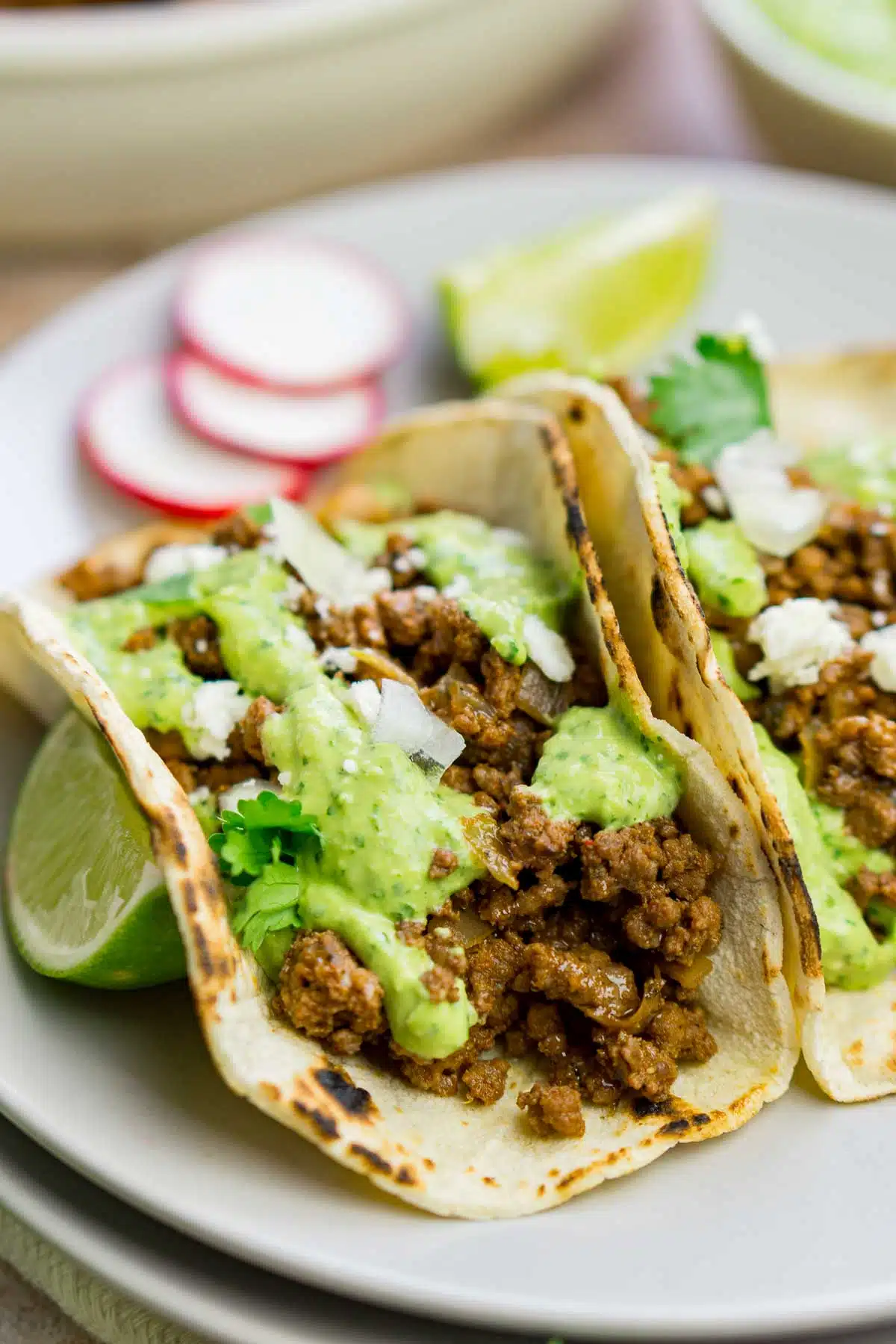 Bison tacos with avocado sauce on a plate