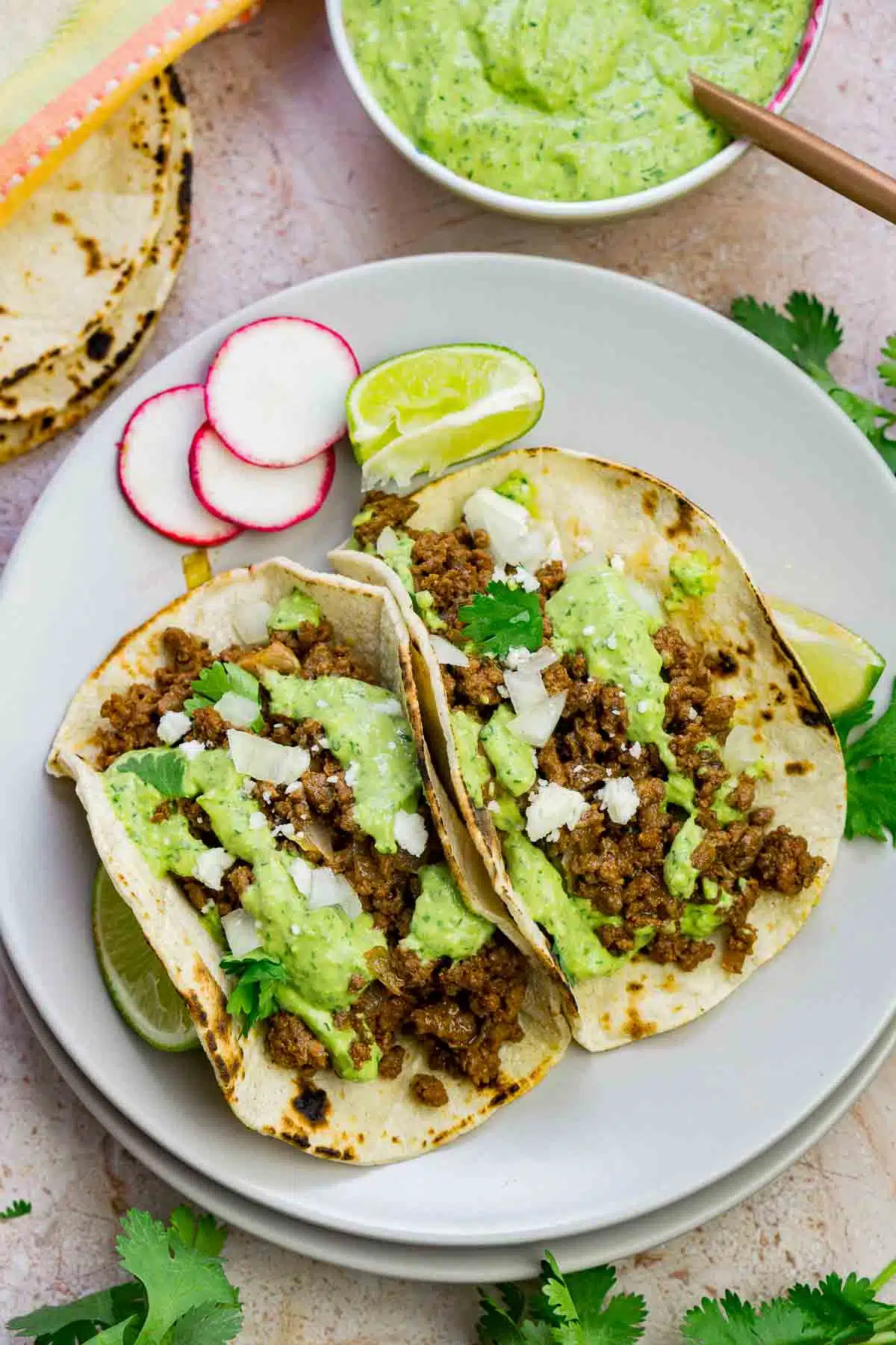 Two bison tacos on a plate